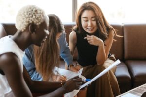 Happy group of women looking at papers