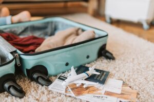 photo of luggage with a passport and toy airplane sitting beside it